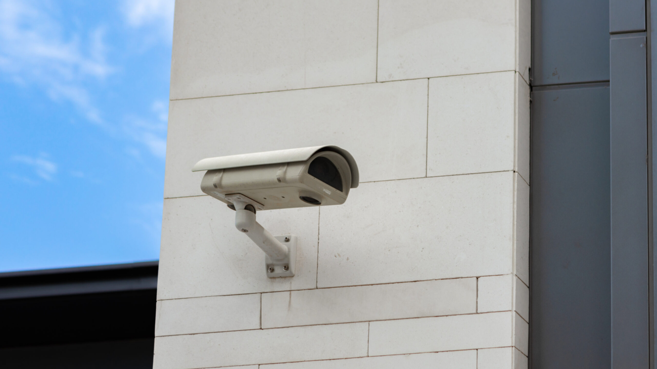 Surveillance camera built into the stone wall of the building, close up